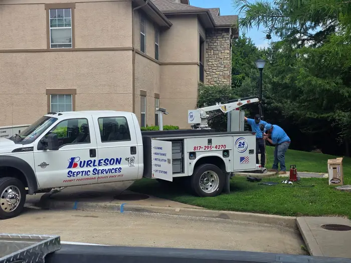 A Burleson Septic service truck working a commercial property